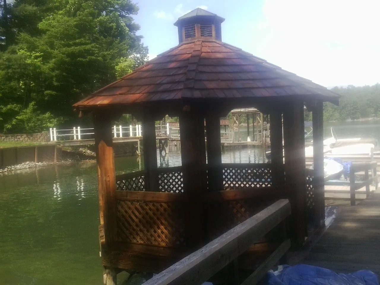 Cedar shake gazebo roof rebuilt on a lake dock in Denmark